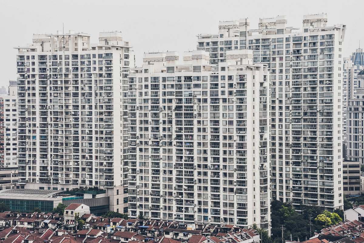 high rise houses by mid-rise buildings during daytime town